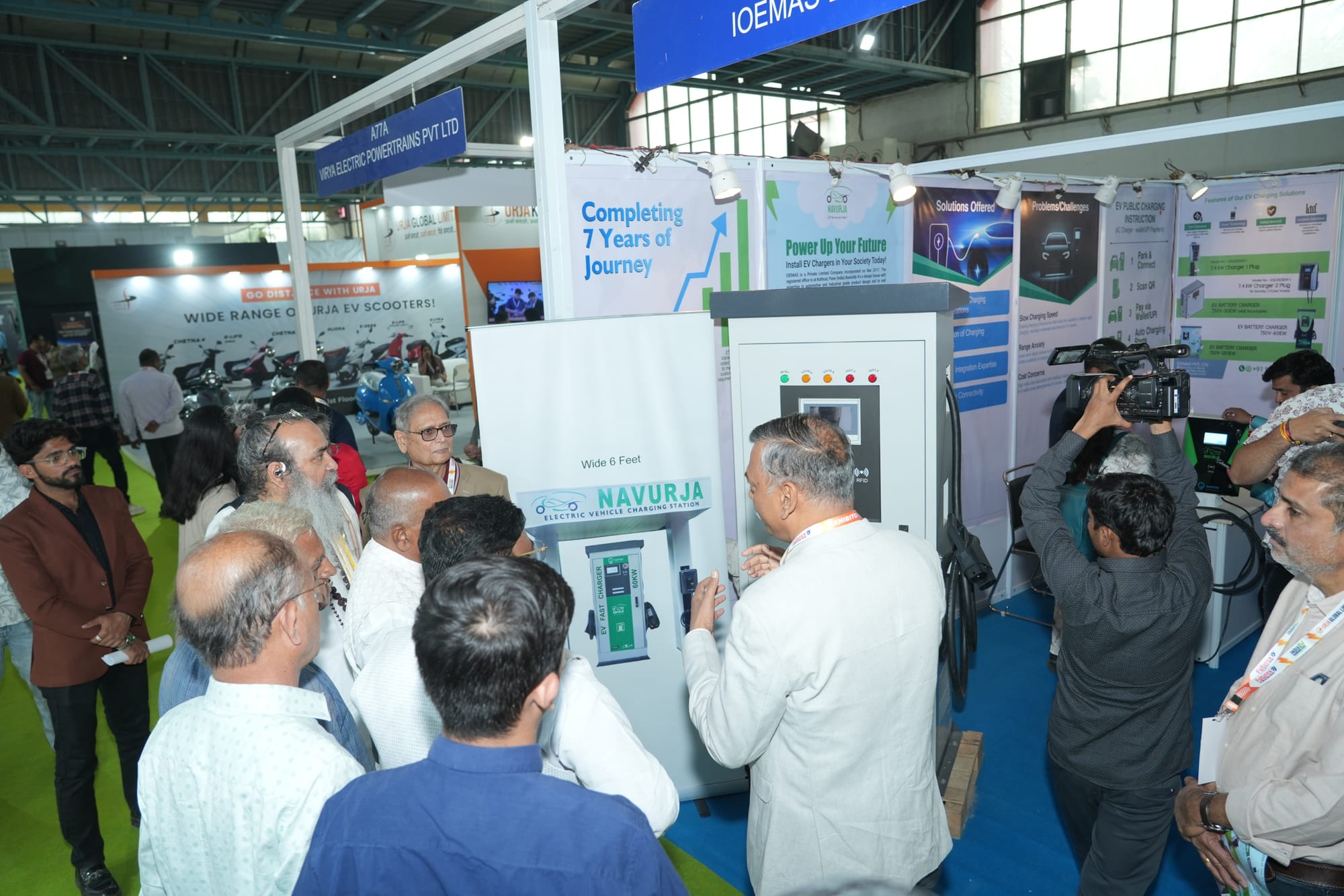 Visitors gathered around an EV charging station display at a previous edition